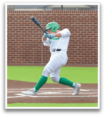 A baseball player in a green shirt and white pants is swinging a bat at a ball. Contenido generado con IA