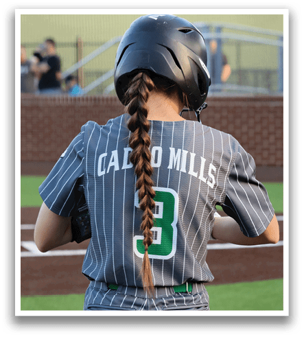 A female baseball player with a long ponytail wearing a grey and green striped jersey. Contenido generado con IA