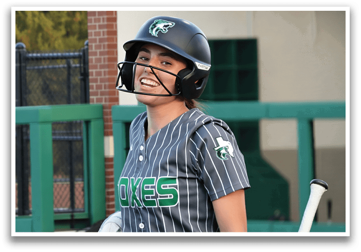 A female baseball player wearing a helmet and a green and white uniform. Contenido generado con IA