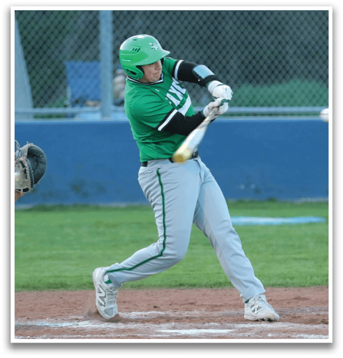 A baseball player in a green shirt and white pants is swinging a bat at a ball. Contenido generado con IA