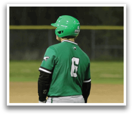 Two baseball players wearing green and white uniforms are standing on a field. Contenido generado con IA