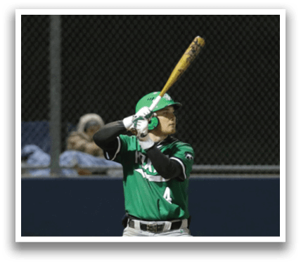 A baseball player is at bat, holding a bat and preparing to swing. Contenido generado con IA