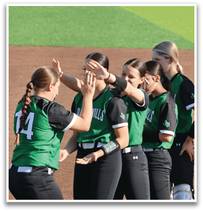 A group of female softball players huddle together on the field. Contenido generado con IA