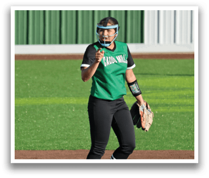 Two female baseball players on a field, one wearing a blue and yellow uniform and the other wearing a green and black uniform. The blue player is holding a baseball bat and the green player is holding a baseball glove. Contenido generado con IA