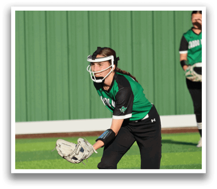 A female baseball player wearing a green and black uniform is catching a ball. Contenido generado con IA