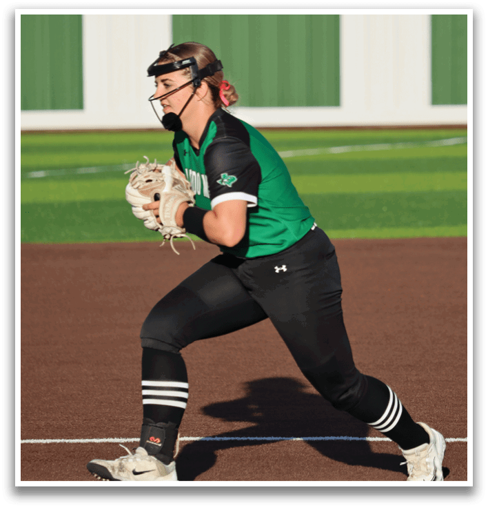 A female baseball player in a green and black uniform is running towards home plate. Contenido generado con IA