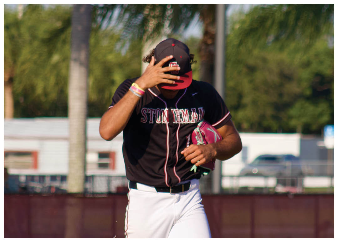 A baseball player is on the mound of a baseball field. Description generated by AI