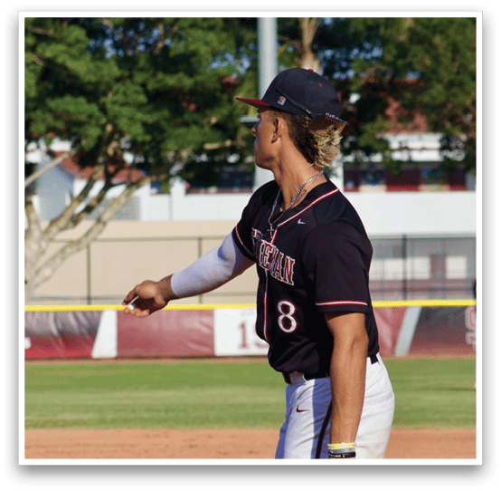 A baseball player wearing a black shirt and white pants. Description generated by AI