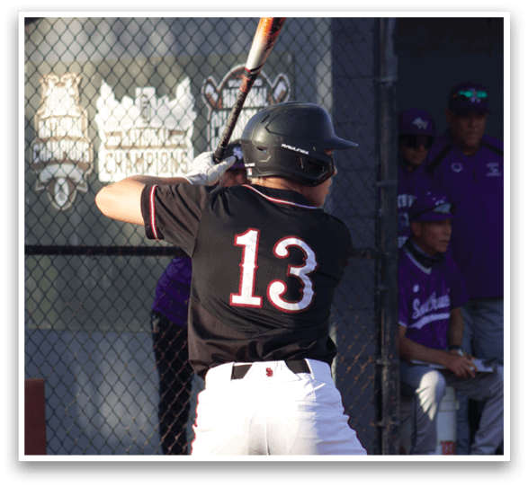 A baseball player is holding a bat and getting ready to swing. Description generated by AI