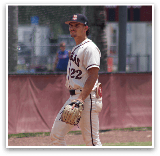 A baseball player in a white uniform stands on the field. Description generated by AI