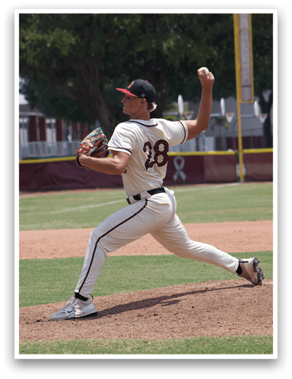 A baseball player in a white uniform is pitching a ball. Description generated by AI