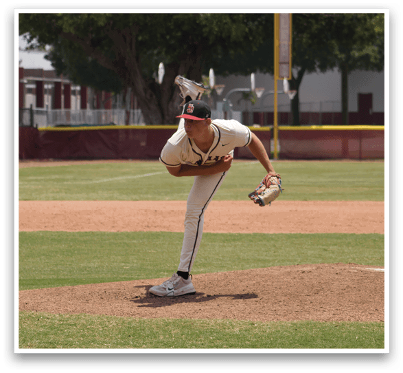 A baseball player in a white uniform is pitching a ball. Description generated by AI