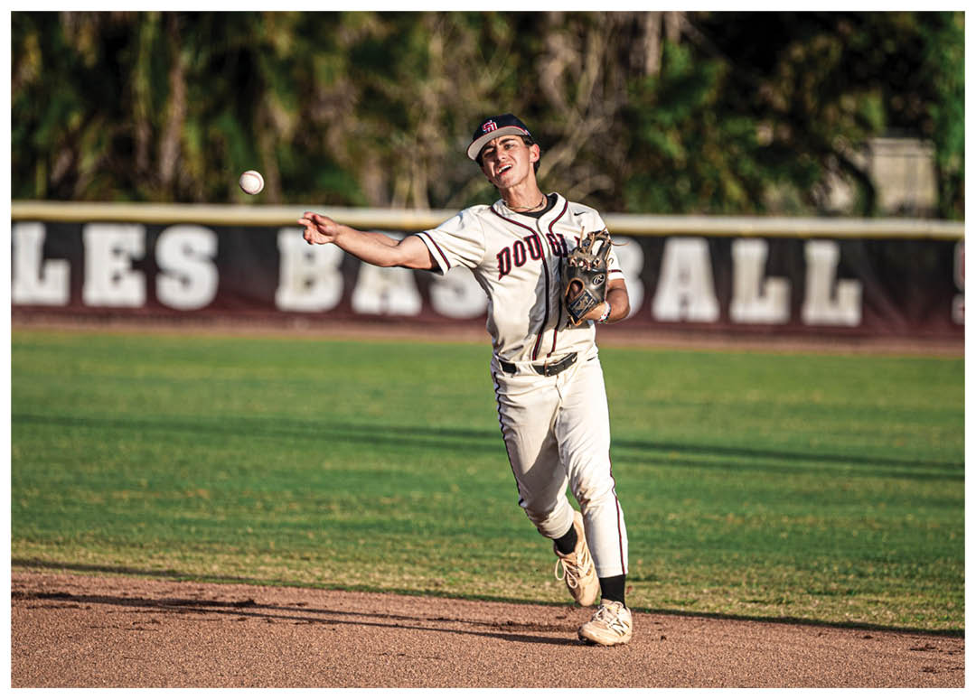 A baseball player catching a ball. Description generated by AI