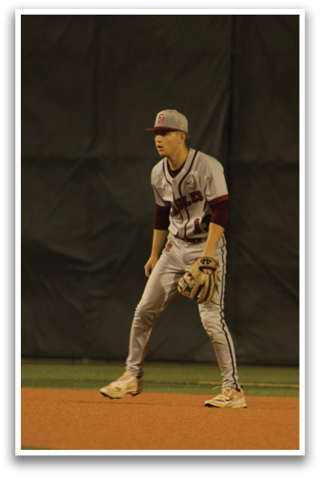 A baseball player wearing a white uniform stands on the field, holding a baseball glove. AI generated content