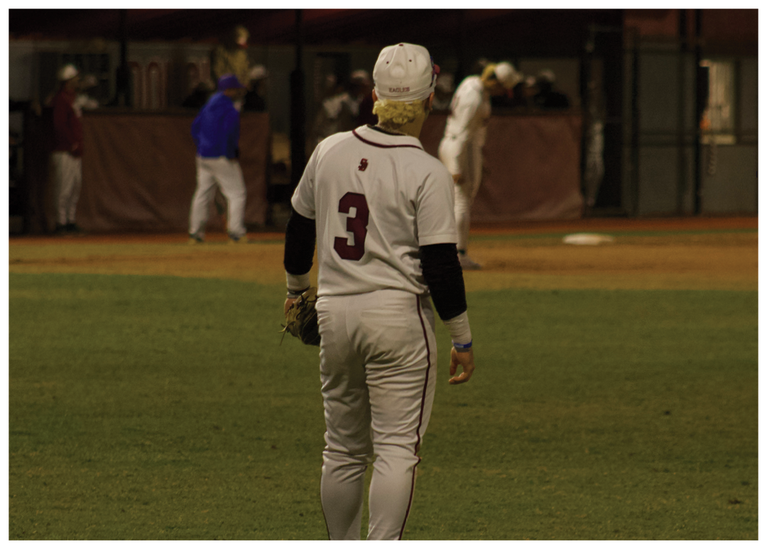 A baseball player wearing a white uniform with the number 9 on the back is walking across a field. AI generated content
