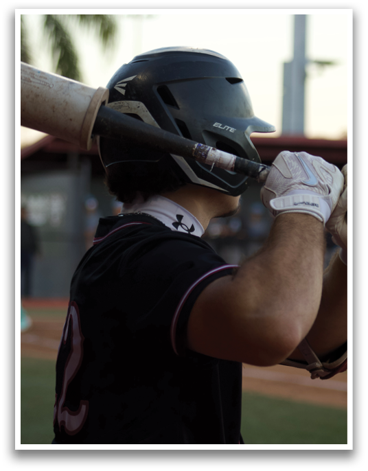 A baseball player is holding a bat, ready to swing. AI generated content