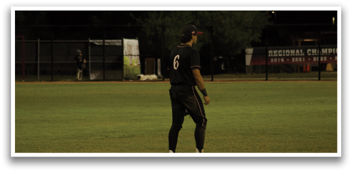 A baseball player wearing a black shirt and white shoes stands on a field. AI generated content