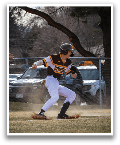 A baseball player in a white uniform is running towards a base. AI generated content