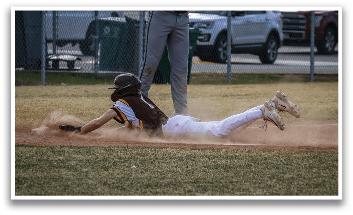 A baseball player slides into a base, with a catcher and an umpire nearby. AI generated content