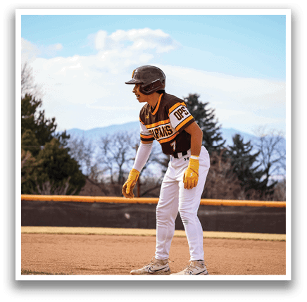 A baseball player in a brown and yellow uniform is standing on the field. AI generated content