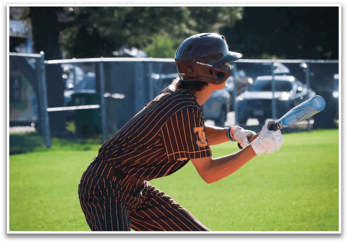 A baseball player in a striped uniform is swinging a bat on a field. AI generated content
