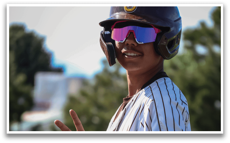 A baseball player wearing a helmet and sunglasses poses for a picture. AI generated content