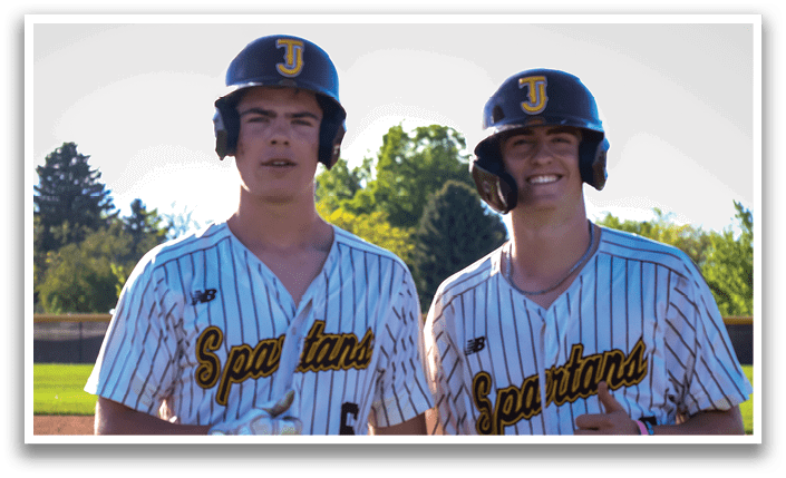 Two baseball players wearing striped uniforms and helmets pose for a picture on a field. AI generated content