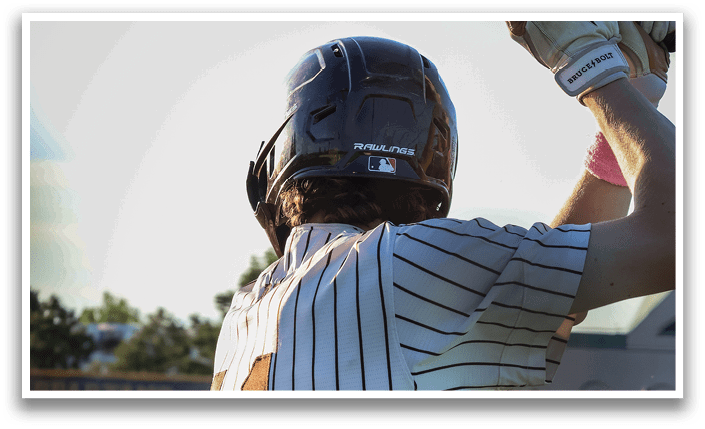A baseball player in a white and black striped uniform is holding a bat, ready to swing. AI generated content