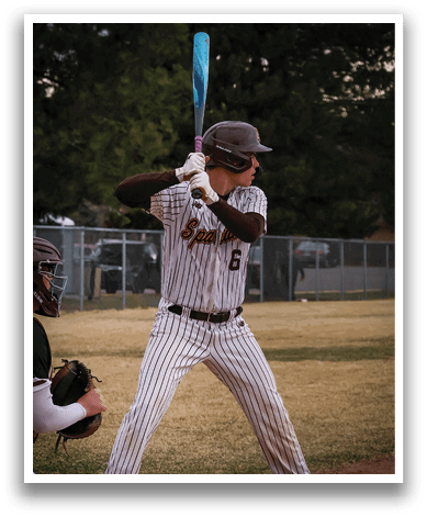 A baseball player is at bat, holding a bat and preparing to swing. AI generated content