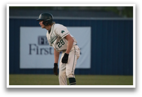 A baseball player is standing on the field, wearing a green and white uniform. AI generated content