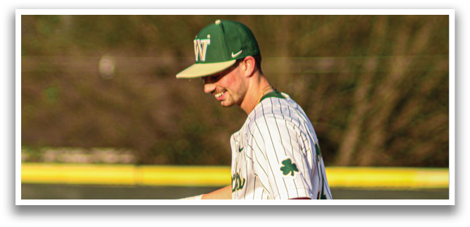 A baseball player wearing a green and white uniform walks across a field. AI generated content