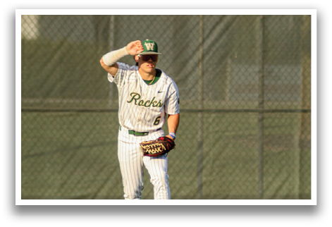 A baseball player wearing a white uniform and a green hat is standing on a field. AI generated content
