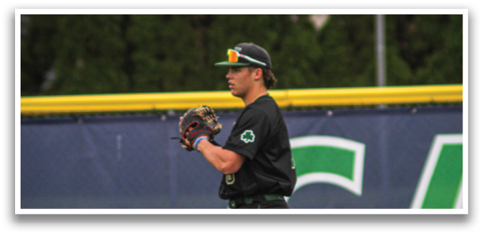 A baseball player wearing a black shirt and green pants is standing on a field. AI generated content