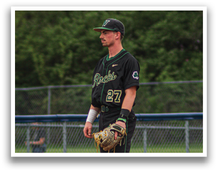 A baseball player wearing a black jersey and green socks stands on the field. AI generated content