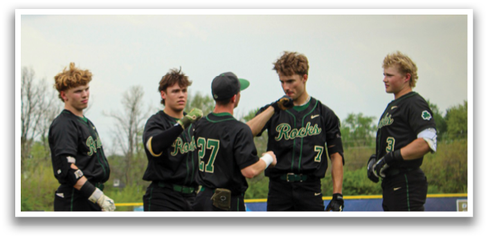 Four baseball players wearing black and green uniforms are standing on a field. AI generated content
