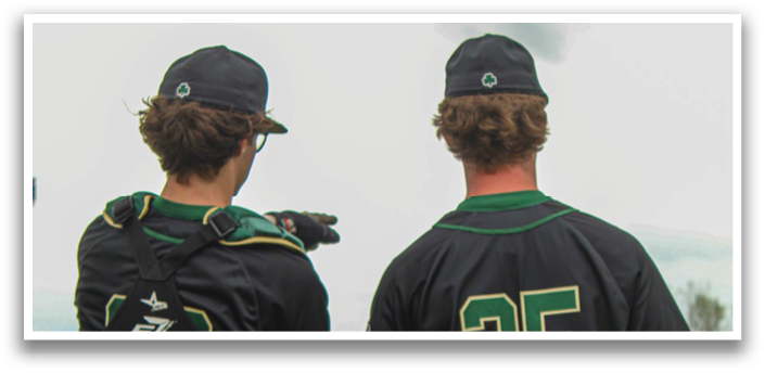 Two baseball players wearing black jerseys and grey shorts stand on a field. AI generated content