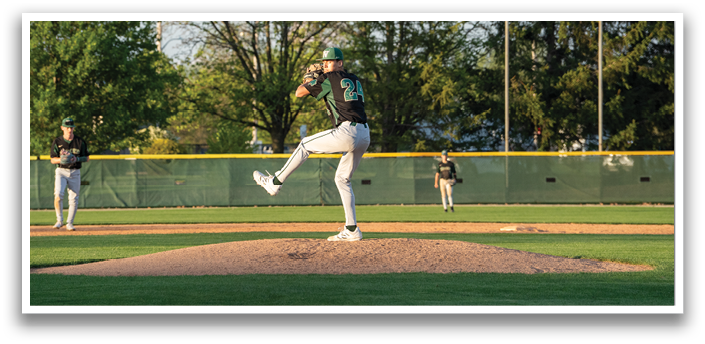 A baseball player in a green shirt and white pants is in the process of throwing a ball. AI generated content