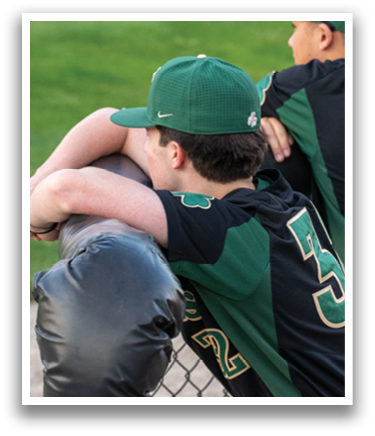 Two baseball players leaning on a fence, one wearing a green hat. AI generated content