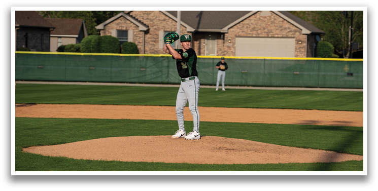 A baseball player in a black shirt and green hat is pitching a ball on a field. AI generated content