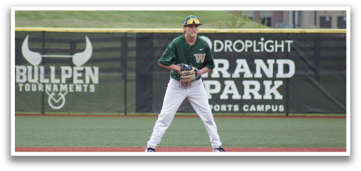 A baseball player in a green and white uniform is standing on the field, holding a baseball glove. AI generated content