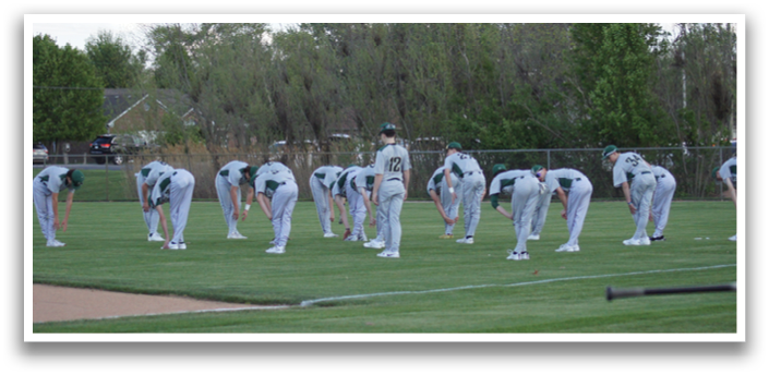 A group of men are standing in a field, wearing baseball uniforms and holding baseball bats. They are all facing the same direction, possibly preparing for a game or practice. AI generated content