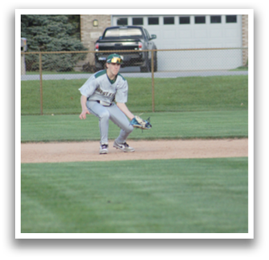A baseball player in a grey uniform is kneeling on the field, wearing a green hat and holding a baseball glove. AI generated content
