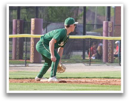 A baseball player in a green uniform is bending over to catch a ball. AI generated content