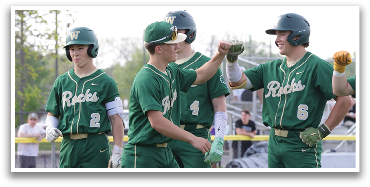 Baseball players wearing green and white uniforms, one of them is holding his hand up. AI generated content