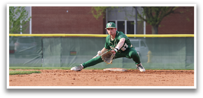 A baseball player in a green uniform is kneeling on the ground with his glove extended, ready to catch the ball. AI generated content