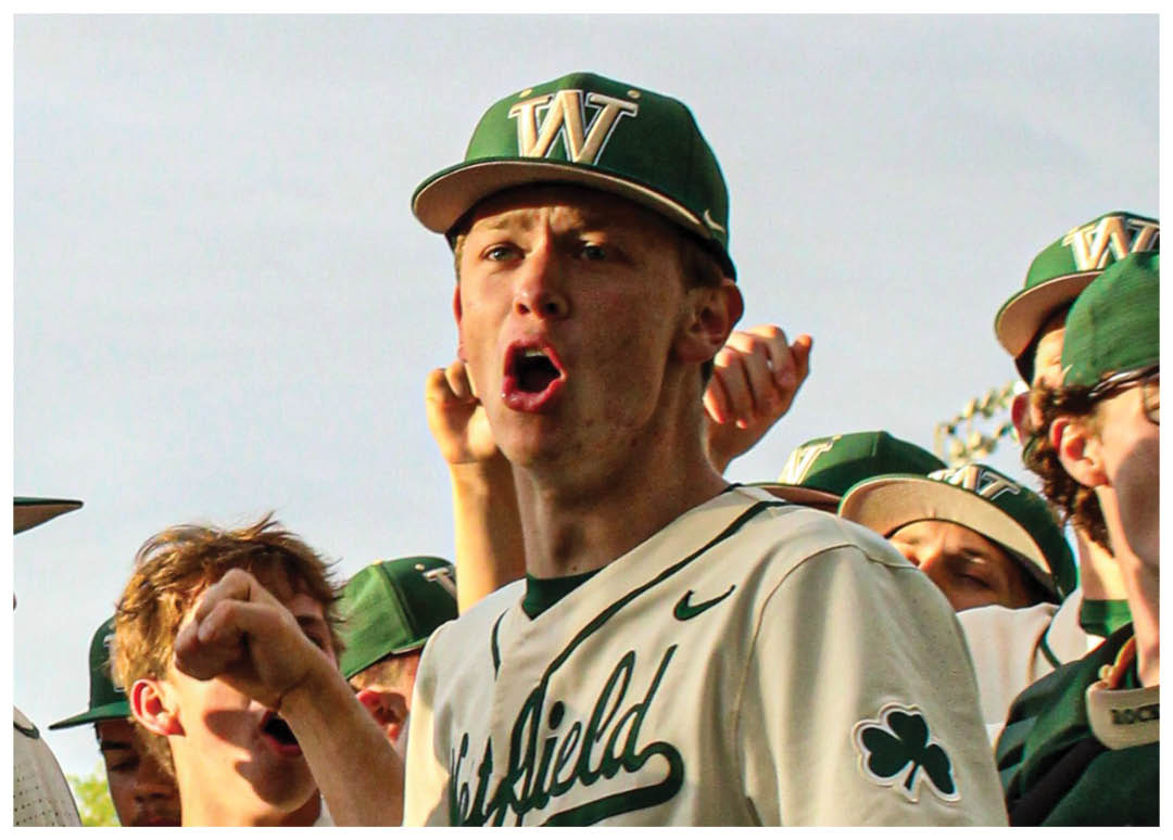 A baseball player wearing a green and white uniform is celebrating with his teammates. AI generated content