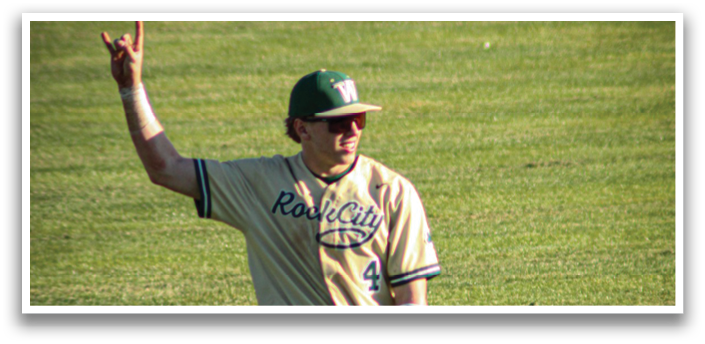 A baseball player wearing a green and white uniform stands on a field holding a mitt. AI generated content