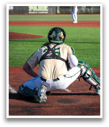 A baseball player is sitting on the ground with his legs crossed, wearing a catcher's mitt. AI generated content