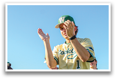 A group of baseball players are on the field, with one man in the center holding his hands up. AI generated content
