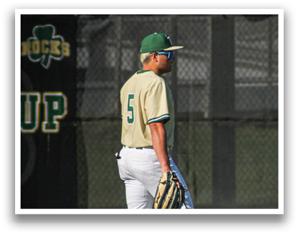 A baseball player wearing a green and white uniform stands on the field. AI generated content